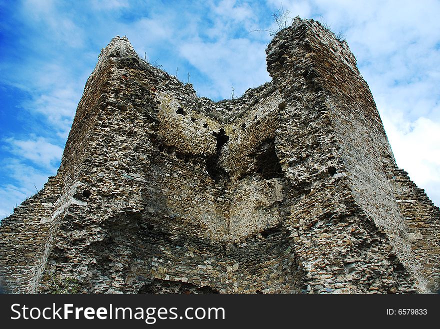 Ruins of a medieval fortress against the blue sky