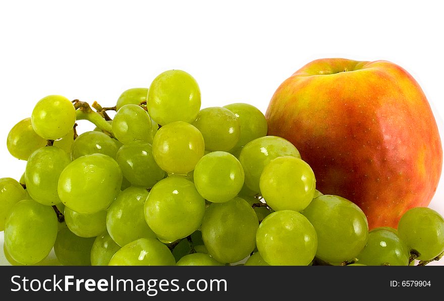 Green grapes and red apple closeup
