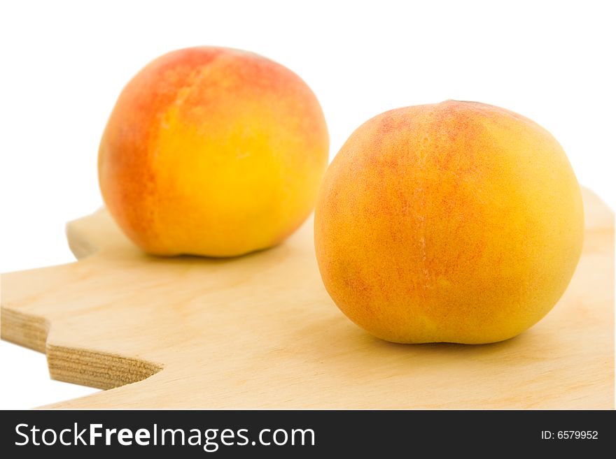 Two appetizing peaches isolated over white