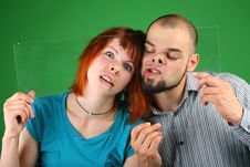 Close Up Girl With Red Hair And Guy Grimace Behind Royalty Free Stock Photography Close Up Girl With Red Hair And Guy Grimace Behind Royalty Free Stock Photography
