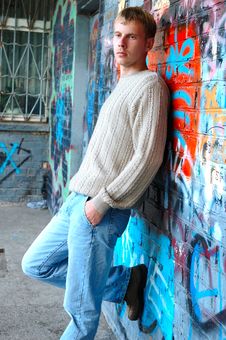 Young Stylish Man Stand Near Graffiti Brick Wall. Stock Photos Young Stylish Man Stand Near Graffiti Brick Wall. Stock Photos