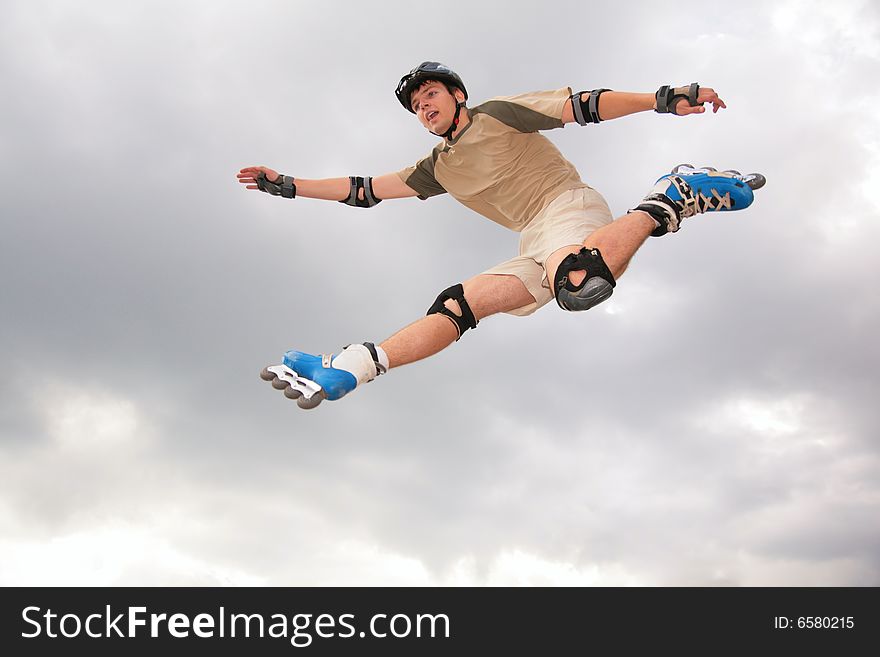 Roller jumping on grey sky