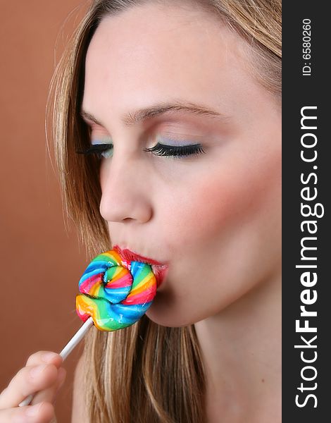 Beautiful young female model with swirl lolly. Beautiful young female model with swirl lolly