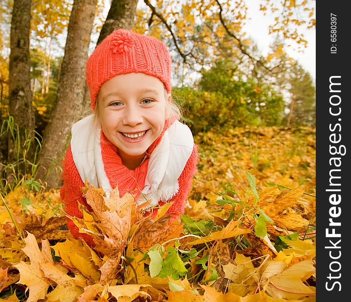 Little girl with autumn leaves