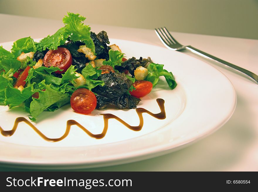 Green salad on a white plate