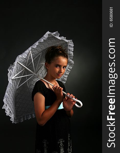 Pretty young girl holding white parasol and a serious expression on her face. Pretty young girl holding white parasol and a serious expression on her face