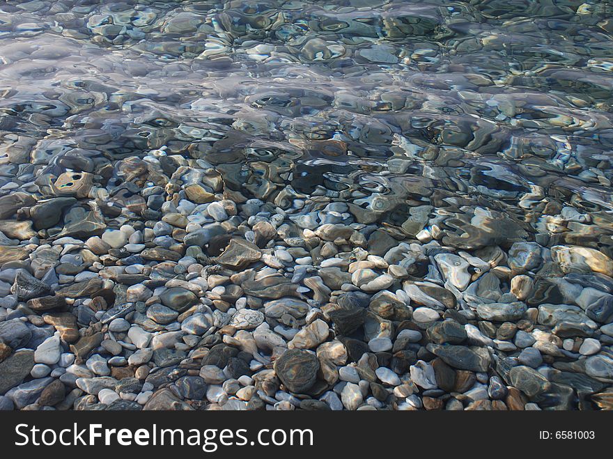 You can see the stones in clean sea. You can see the stones in clean sea