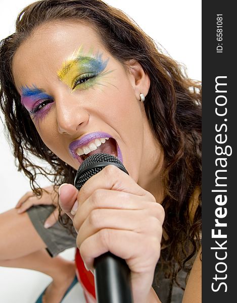 Close up of woman singing into microphone