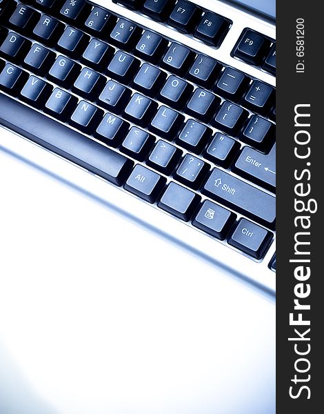 Fragment of keyboard, copy space for the text, blue toned image. Fragment of keyboard, copy space for the text, blue toned image