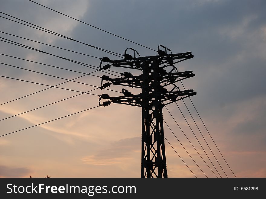 The steel power line pylon in the sunset. The steel power line pylon in the sunset.