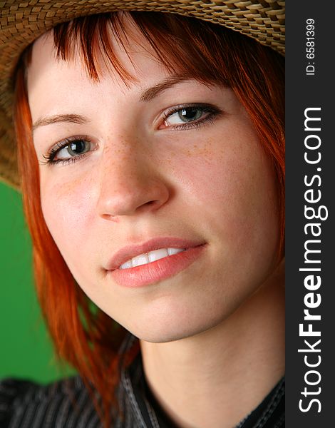 Portrait of girl with red hair on green
