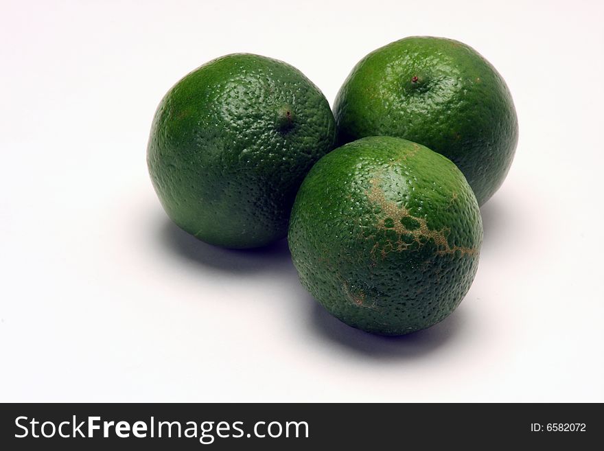 Close up of green limes on white background