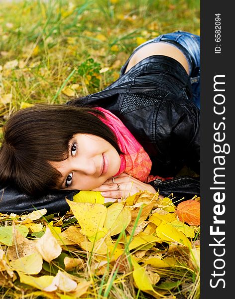 Beautiful girl relaxing in the park on the grass