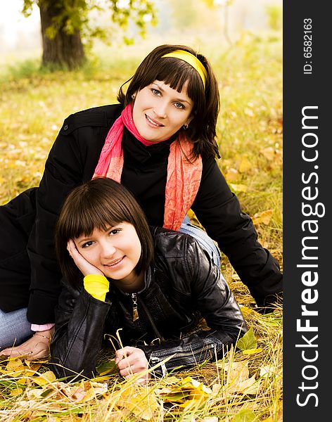 Two girls on the grass in the park