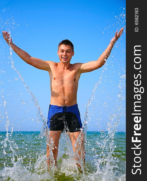 Man in sea water splash, summer