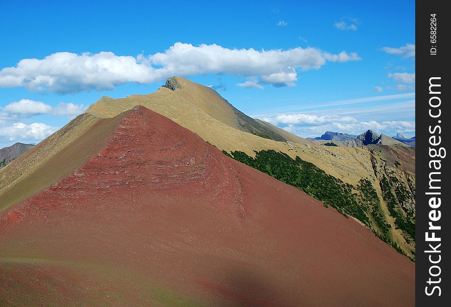 A red color mountain peak on Carthew-Alderson Trail in Waterton National Park Alberta Canada. A red color mountain peak on Carthew-Alderson Trail in Waterton National Park Alberta Canada