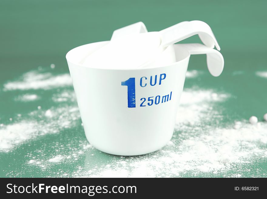 Measuring cups isolated against a green background