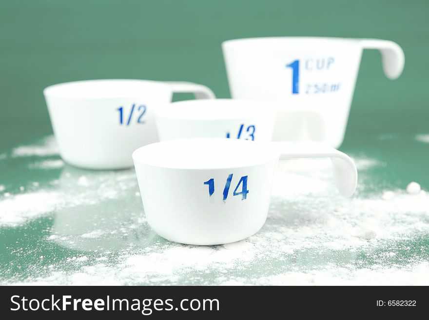 Measuring cups isolated against a green background