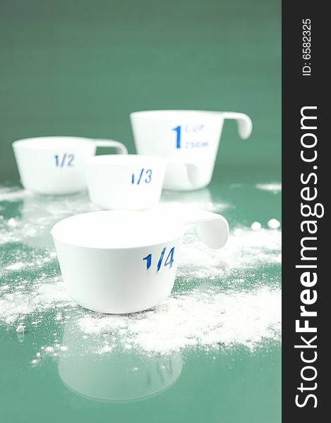 Measuring cups isolated against a green background