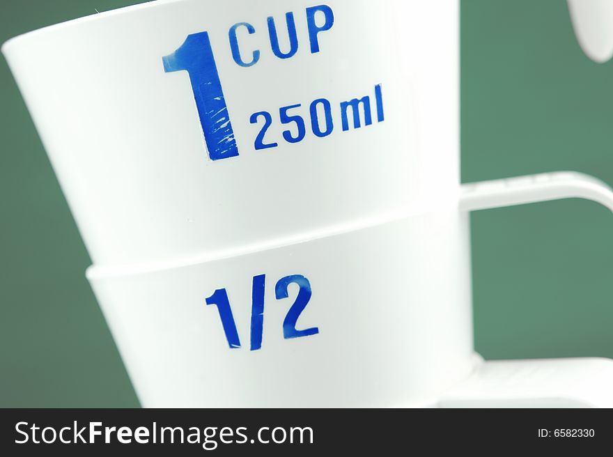 Measuring cups isolated against a green background