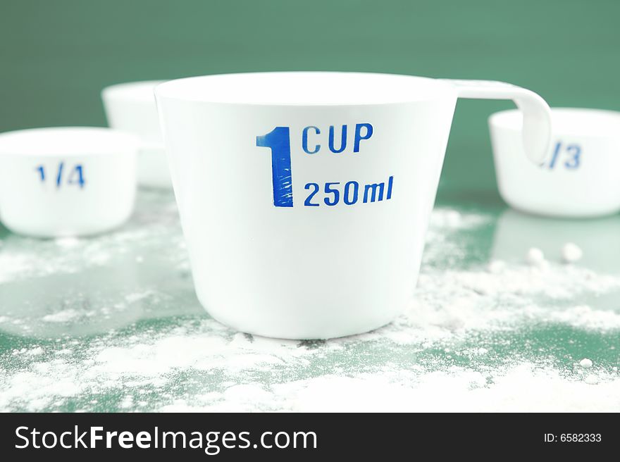 Measuring cups isolated against a green background