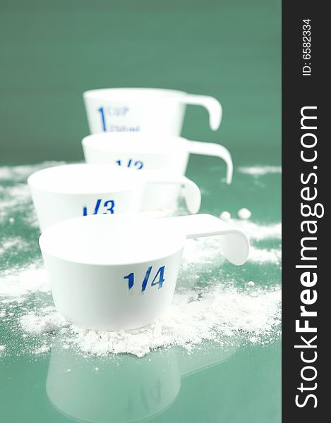 Measuring cups isolated against a green background