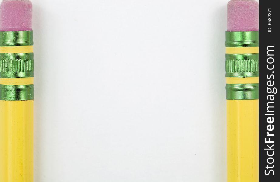 Two pencils framing a white backround. Two pencils framing a white backround.