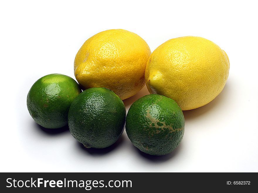 Three whole limes and two whole lemons on white background. Three whole limes and two whole lemons on white background