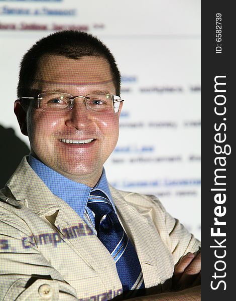 Smiling businessman from screen in glasses smiling