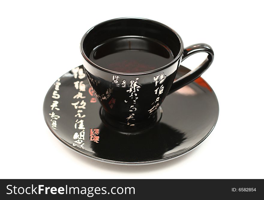 Black cup of tea on awhite background