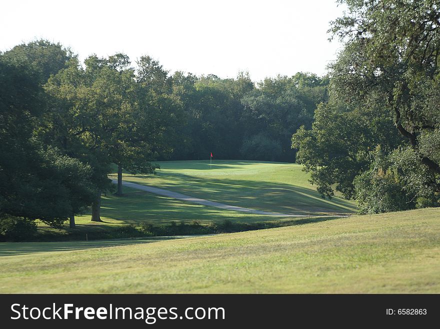 A view of the green on a scenic hill country golf course. A view of the green on a scenic hill country golf course