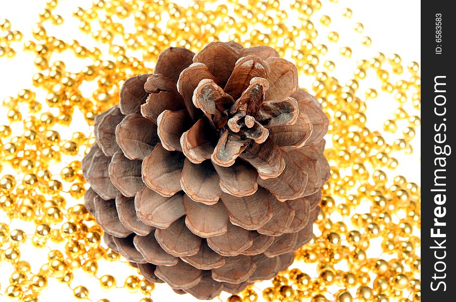 Cone on gold chain isolated on golden background. Cone on gold chain isolated on golden background