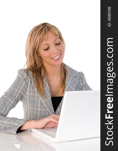 Portrait of confident business woman sitting at the table and typing a document on the laptop. Portrait of confident business woman sitting at the table and typing a document on the laptop