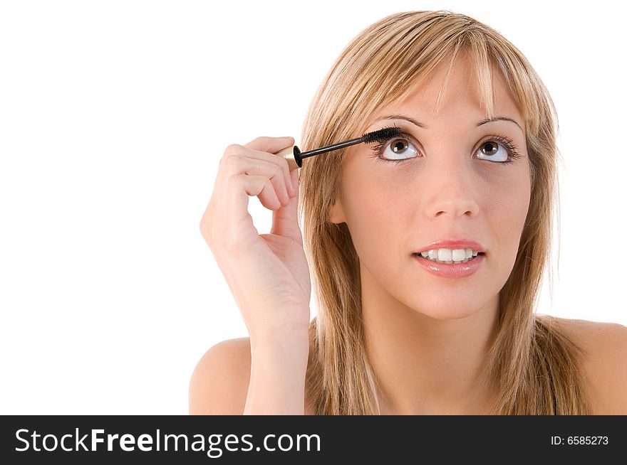 Girl applying mascara. Make up