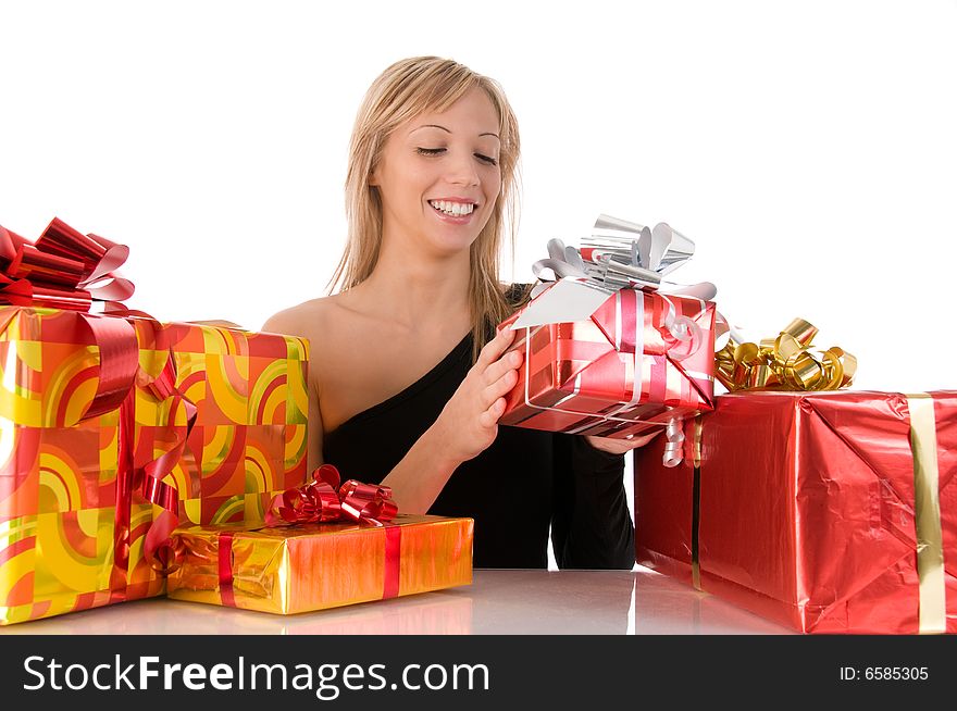 Beautiful young woman opening the colorful gifts. Beautiful young woman opening the colorful gifts