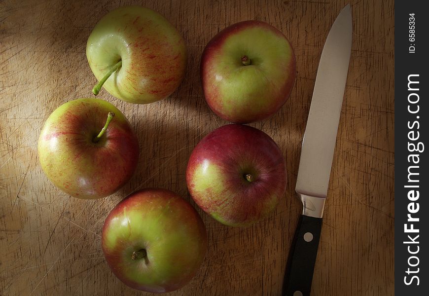 Apples And Knife On Old Chopping Board.