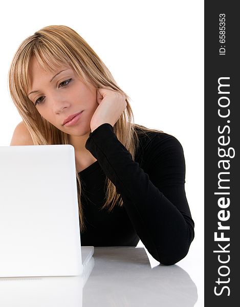 Closeup portrait of a young woman concentrated using laptop. On white background