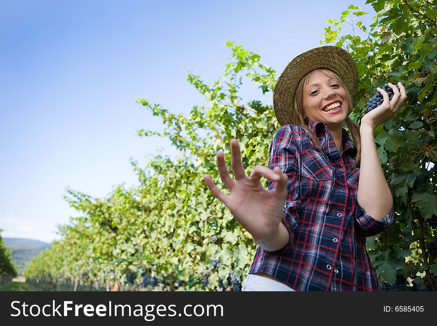 Young peasant woman grape sign ok with hand