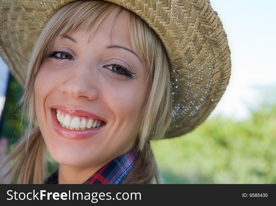Closeup portrait of a happy young peasant woman among the vineyards