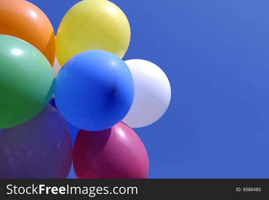 Vibrant bold balloons against a bright blue sky. Vibrant bold balloons against a bright blue sky