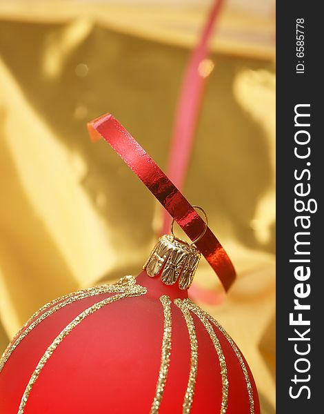 Christmas red ball on golden background.