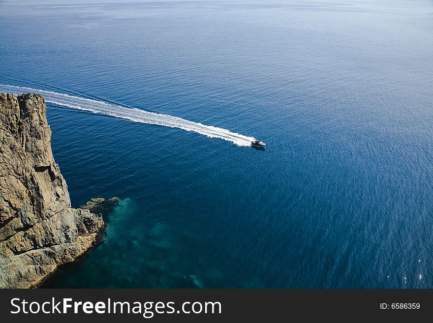 Speedy motorboat aerial view on blue ocean background