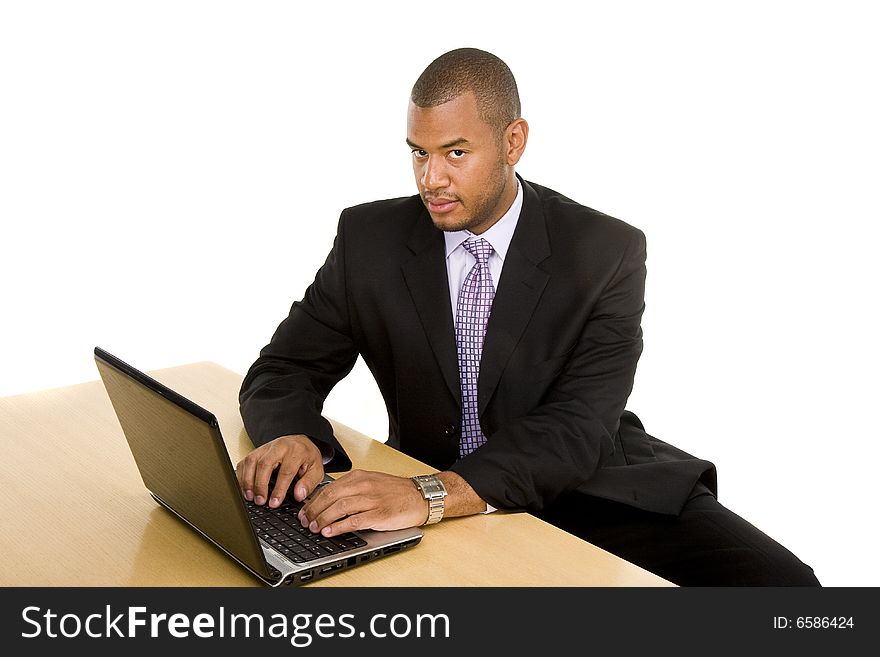 Serious Businessman at Desk Working on Laptop