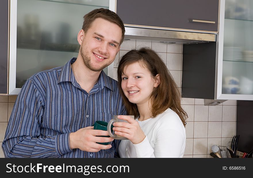 Casual couple together in modern kitchen. Casual couple together in modern kitchen