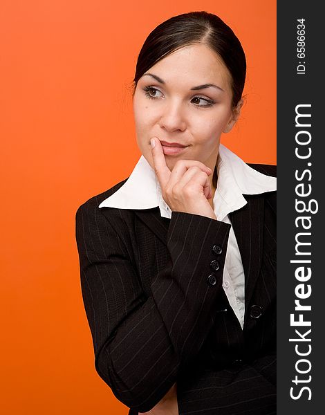 Attractive brunette businesswoman. Over orange background