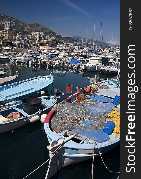 Fishing Boats and Luxury Boats all together in Marina, Monaco, France. Fishing Boats and Luxury Boats all together in Marina, Monaco, France