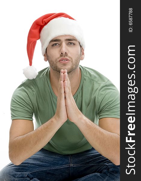 Praying man with santa cap on an isolated background