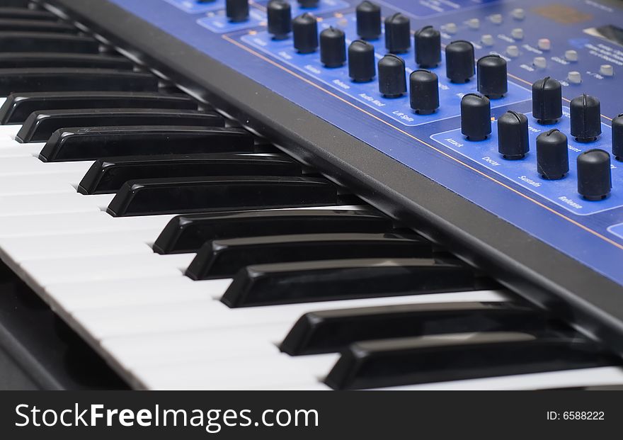 Closeup of synthesizer with keyboard and controls