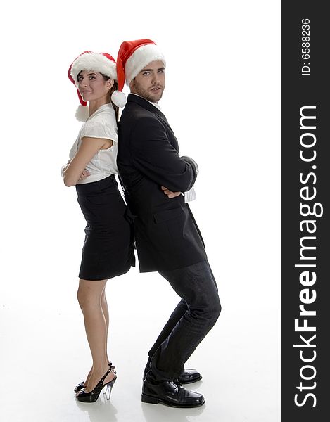 Smiling couple posing with santa cap on an isolated white background