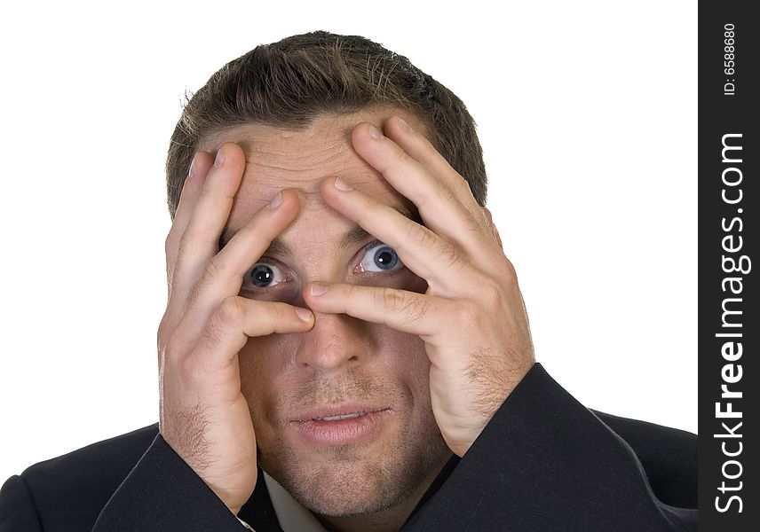 Businessman peeking behind his hand against white background